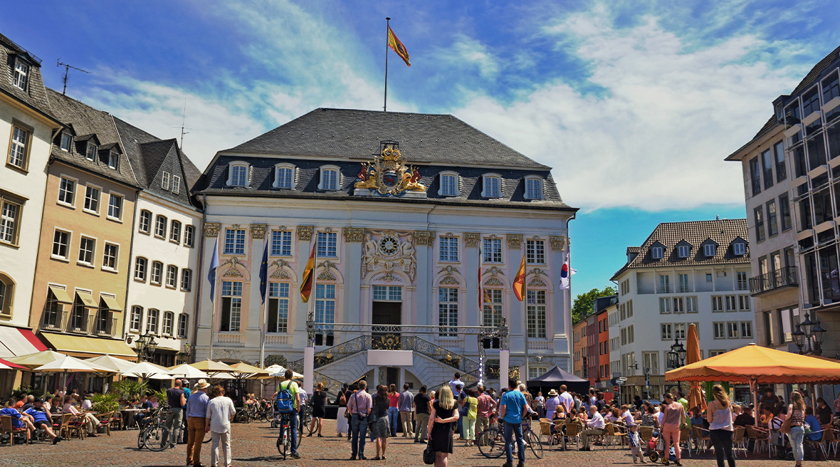 crowd of people gathered outside of the Old Town Hall in Bonn